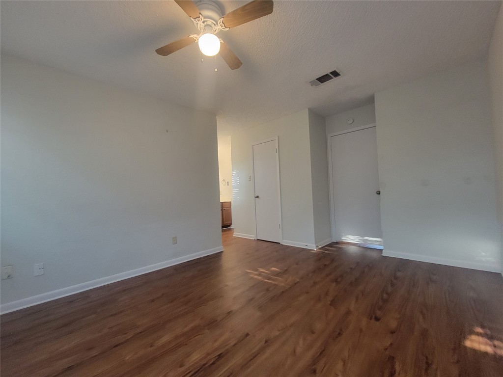 7825 Beauregard Circle, Unit 2A Austin, TX 78745 - Photo 18 of 27 a view of an empty room with wooden floor