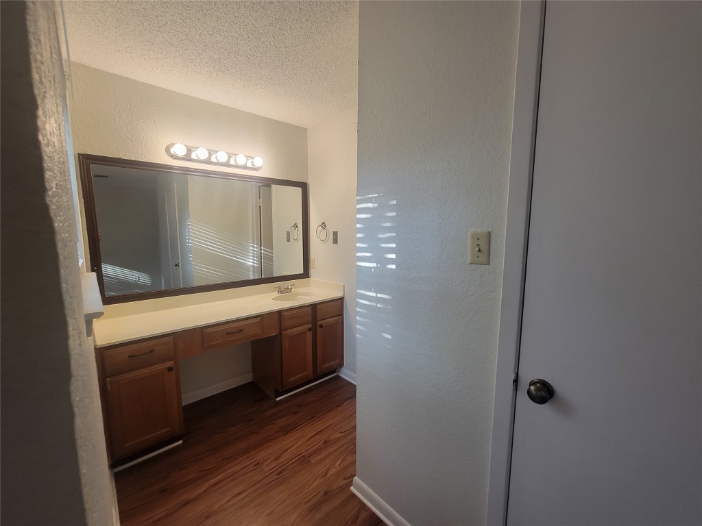 7825 Beauregard Circle, Unit 2A Austin, TX 78745 - Photo 19 of 27 a bathroom with a sink and a mirror