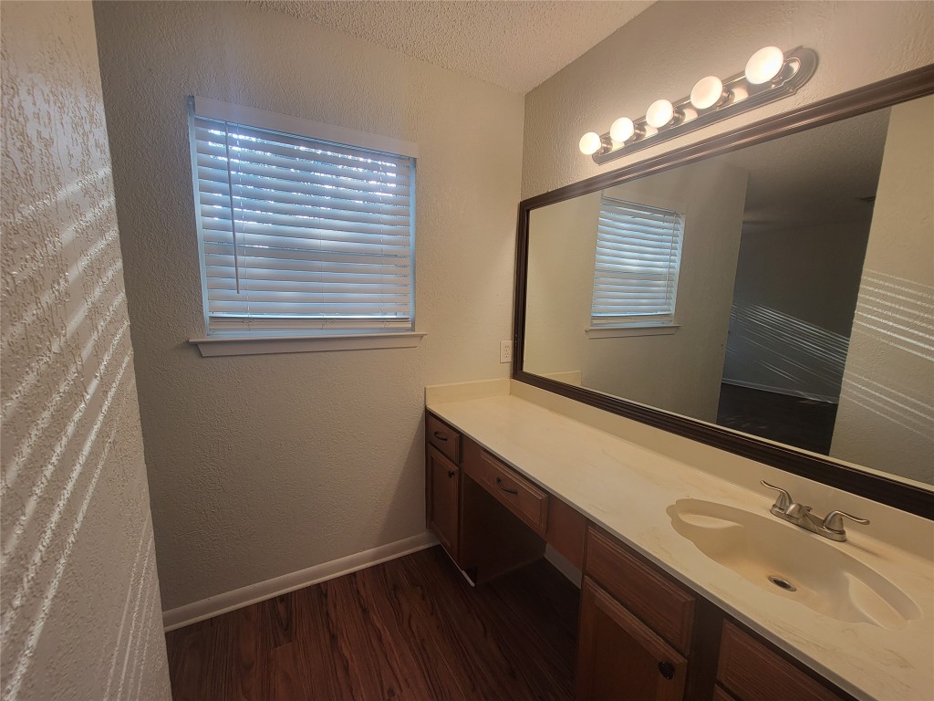 7825 Beauregard Circle, Unit 2A Austin, TX 78745 - Photo 20 of 27 a bathroom with a sink and a mirror