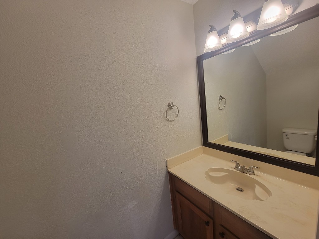 7825 Beauregard Circle, Unit 2A Austin, TX 78745 - Photo 21 of 27 a bathroom with a sink and a mirror