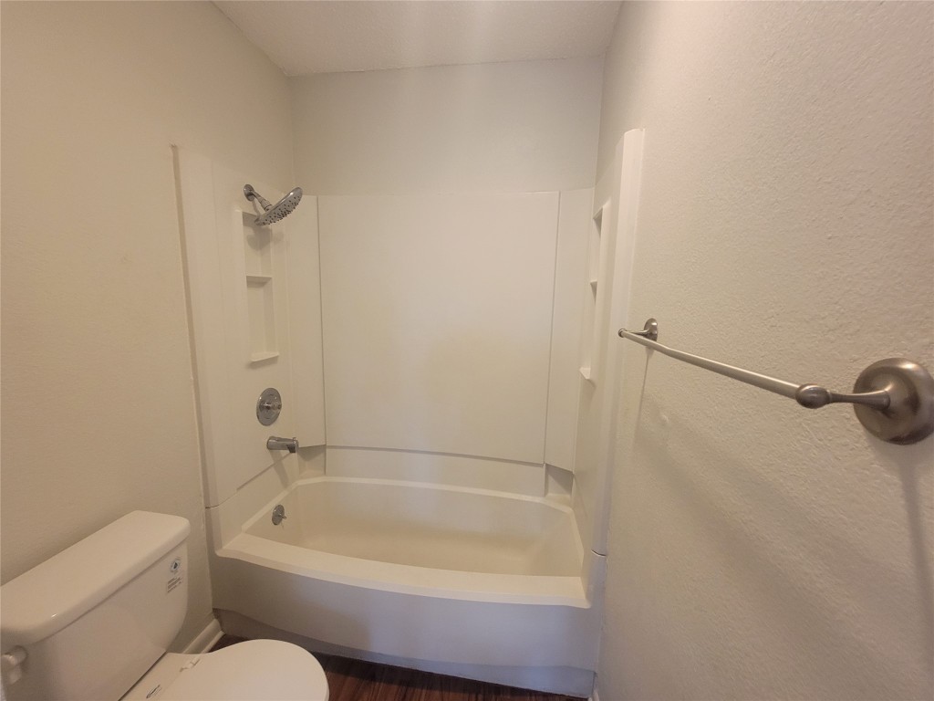 7825 Beauregard Circle, Unit 2A Austin, TX 78745 - Photo 22 of 27 a bathroom with a granite countertop bathtub shower and toilet