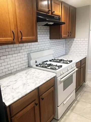 a kitchen with granite countertop cabinets and black appliances