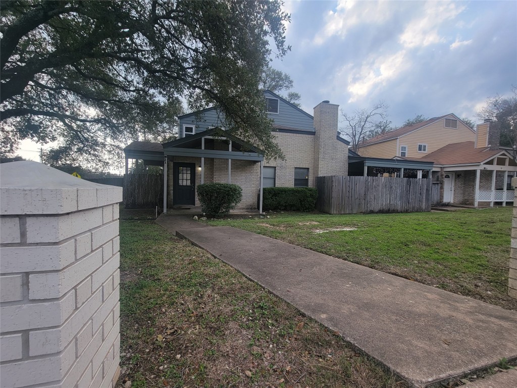 7825 Beauregard Circle, Unit 2A Austin, TX 78745 - Photo 10 of 27 a front view of a house with a yard