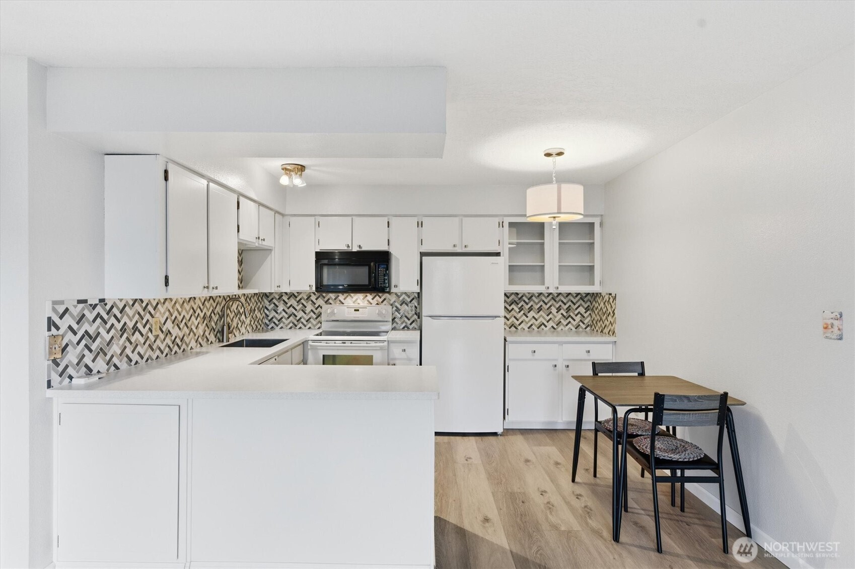 2005 Tibbetts Drive, Unit 209 Longview, WA 98632 - Photo 19 of 40 a kitchen with kitchen island white cabinets and stainless steel appliances