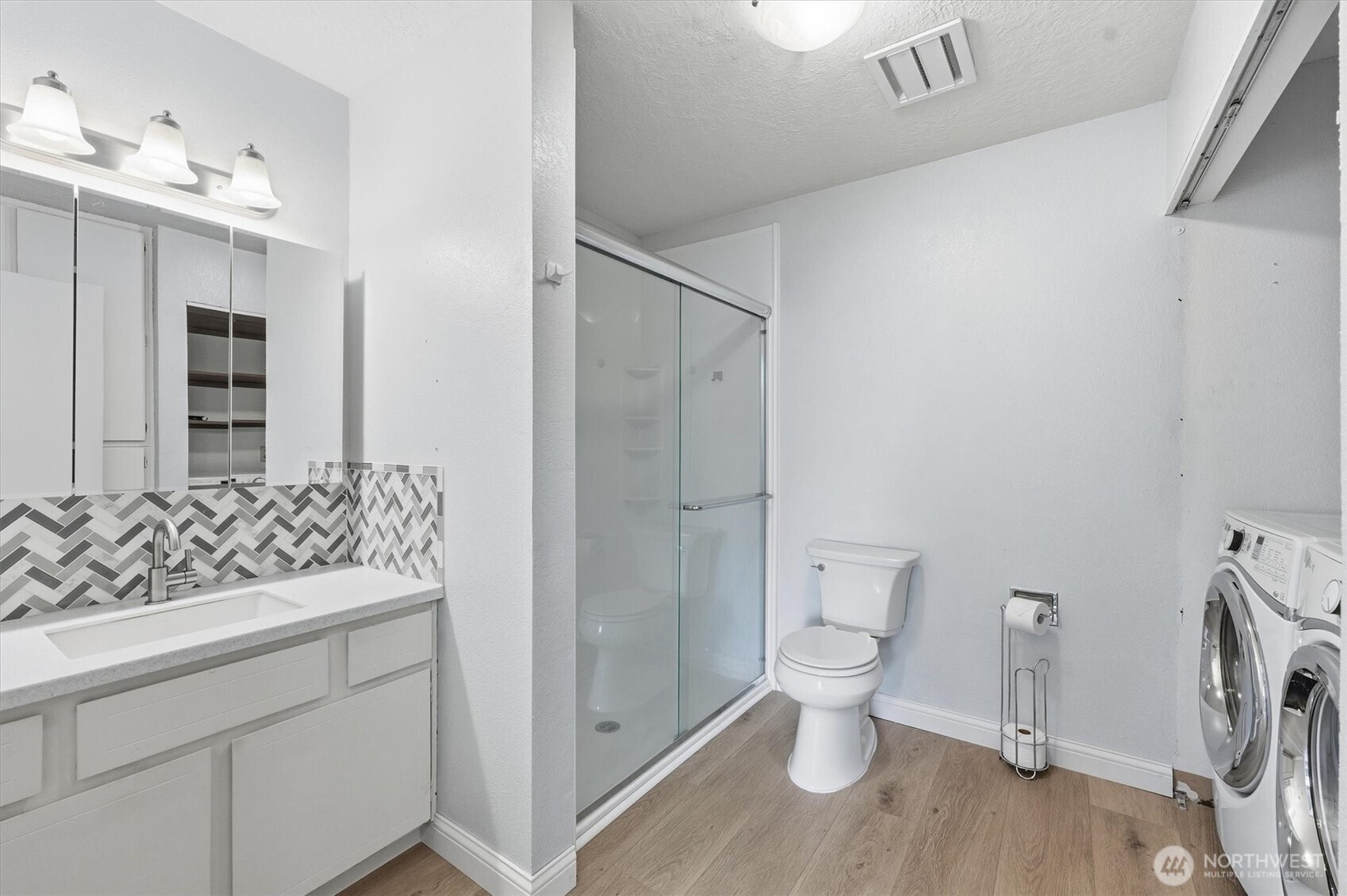 2005 Tibbetts Drive, Unit 209 Longview, WA 98632 - Photo 28 of 40 a bathroom with a sink toilet vanity and shower