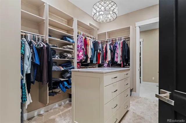 a view of walk in closet with clothes