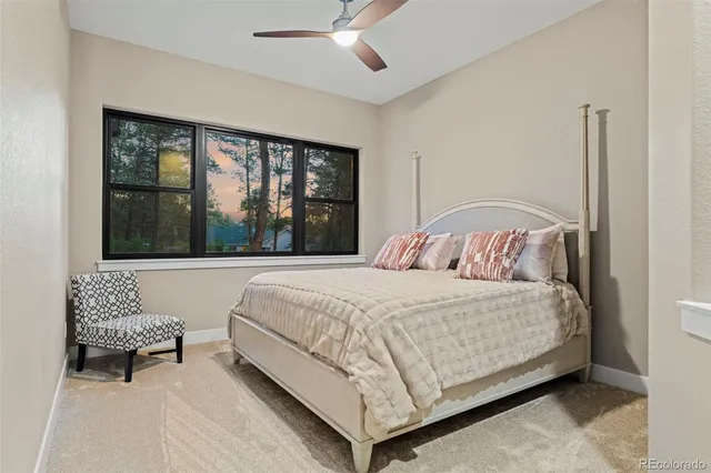 a large living room with stainless steel appliances kitchen island a fireplace and a refrigerator