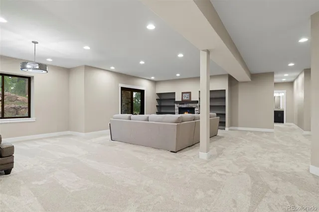 a living room with furniture a chandelier and a window