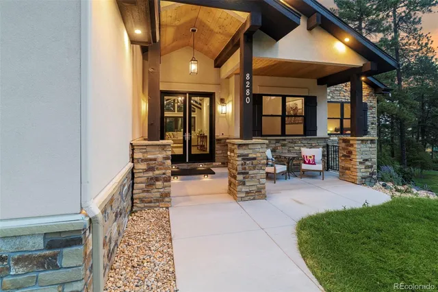a view of a patio with table and chairs potted plants and a barbeque
