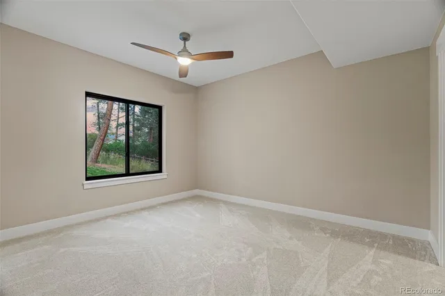 a balcony with wooden floor table and chairs