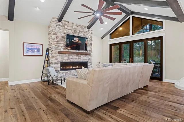 a living room with furniture a fireplace and a flat screen tv