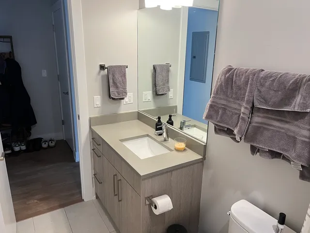 a bathroom with a double vanity sink and a mirror