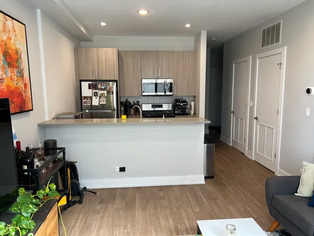 a view of a kitchen with furniture and wooden floor