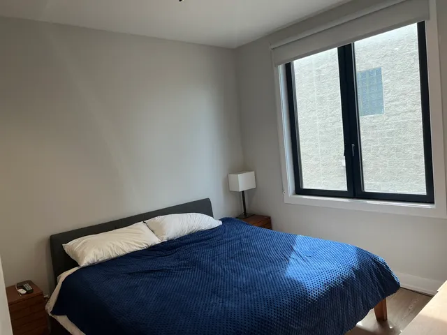 a bedroom with a bed and window