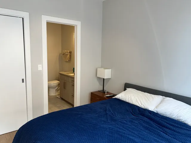 a bedroom with a bed and a lamp