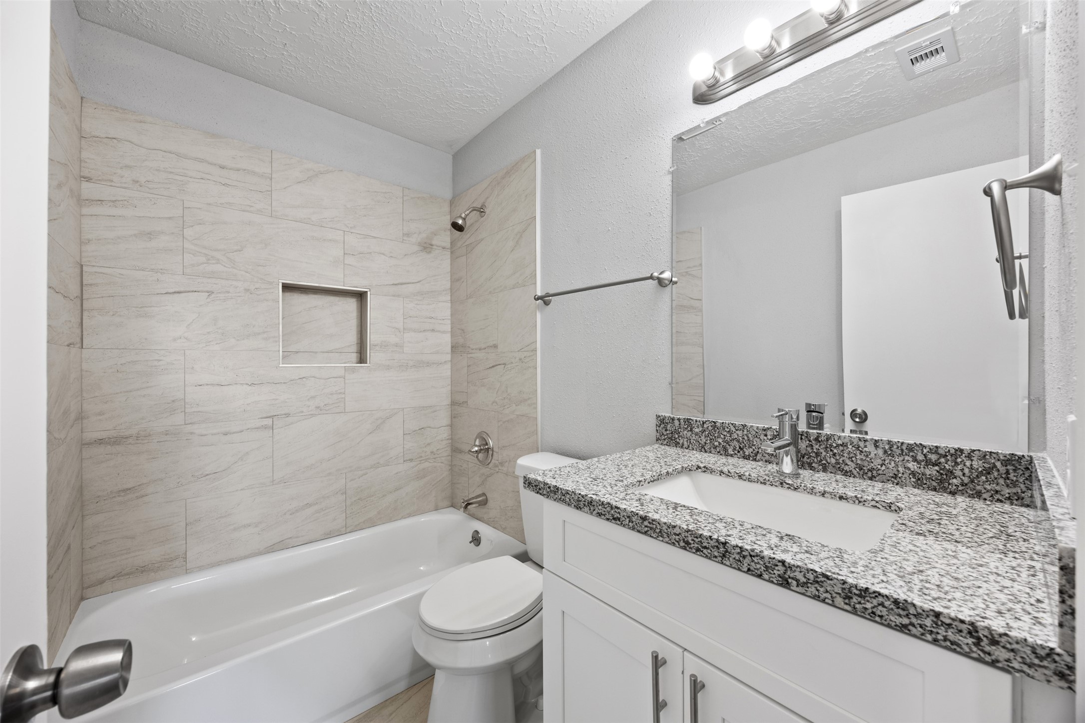 3030 Becket Street Pearland, TX 77584 - Photo 15 of 22 a bathroom with a granite countertop sink a toilet and bathtub