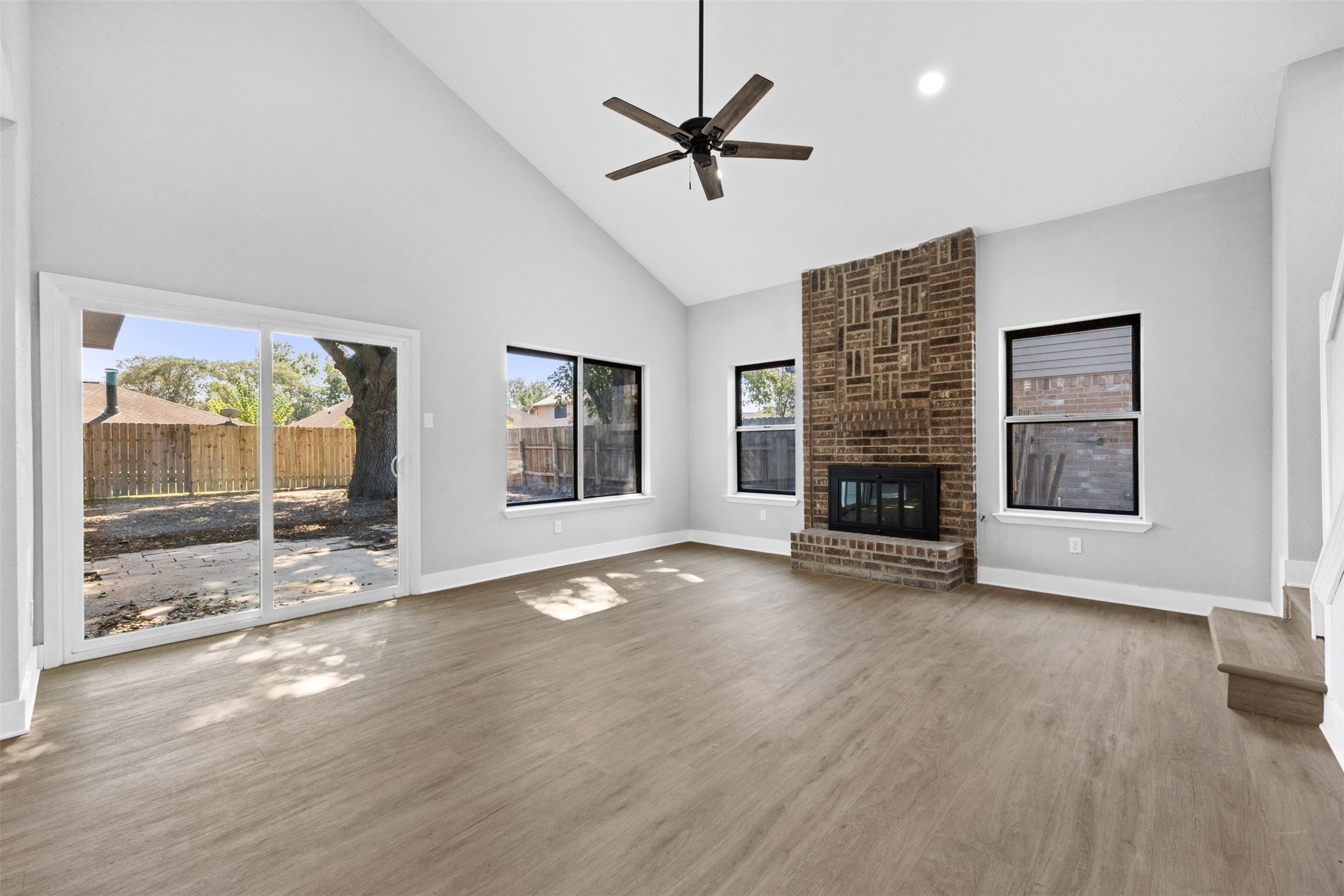 3030 Becket Street Pearland, TX 77584 - Photo 2 of 22 a view of livingroom with fireplace a ceiling fan and window