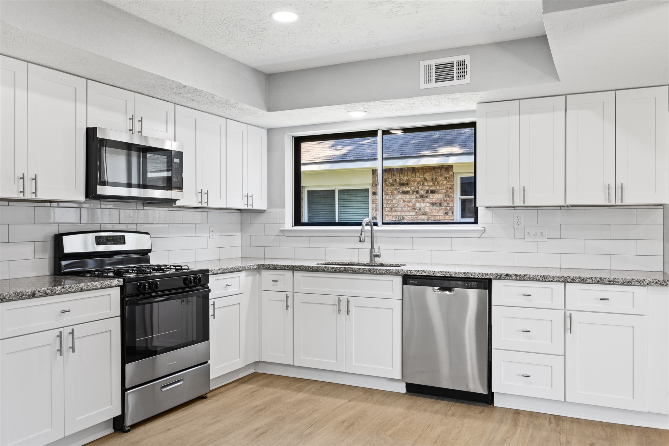 3030 Becket Street Pearland, TX 77584 - Photo 3 of 22 a kitchen with white cabinets appliances and a sink