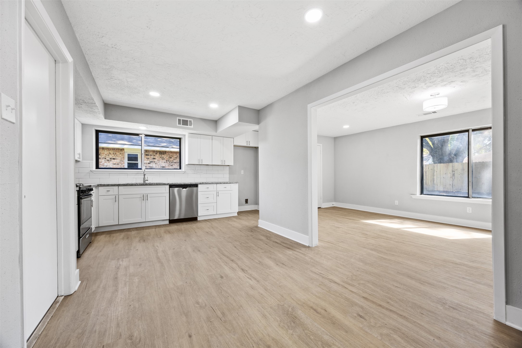 3030 Becket Street Pearland, TX 77584 - Photo 10 of 22 a view of a kitchen with a sink and a refrigerator