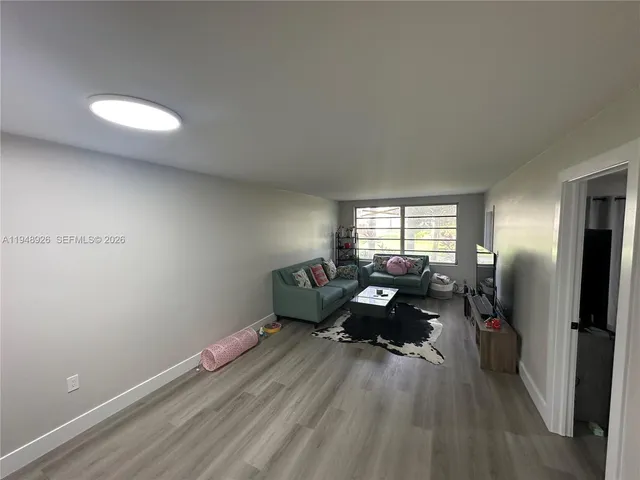 a living room with furniture window and flat screen tv
