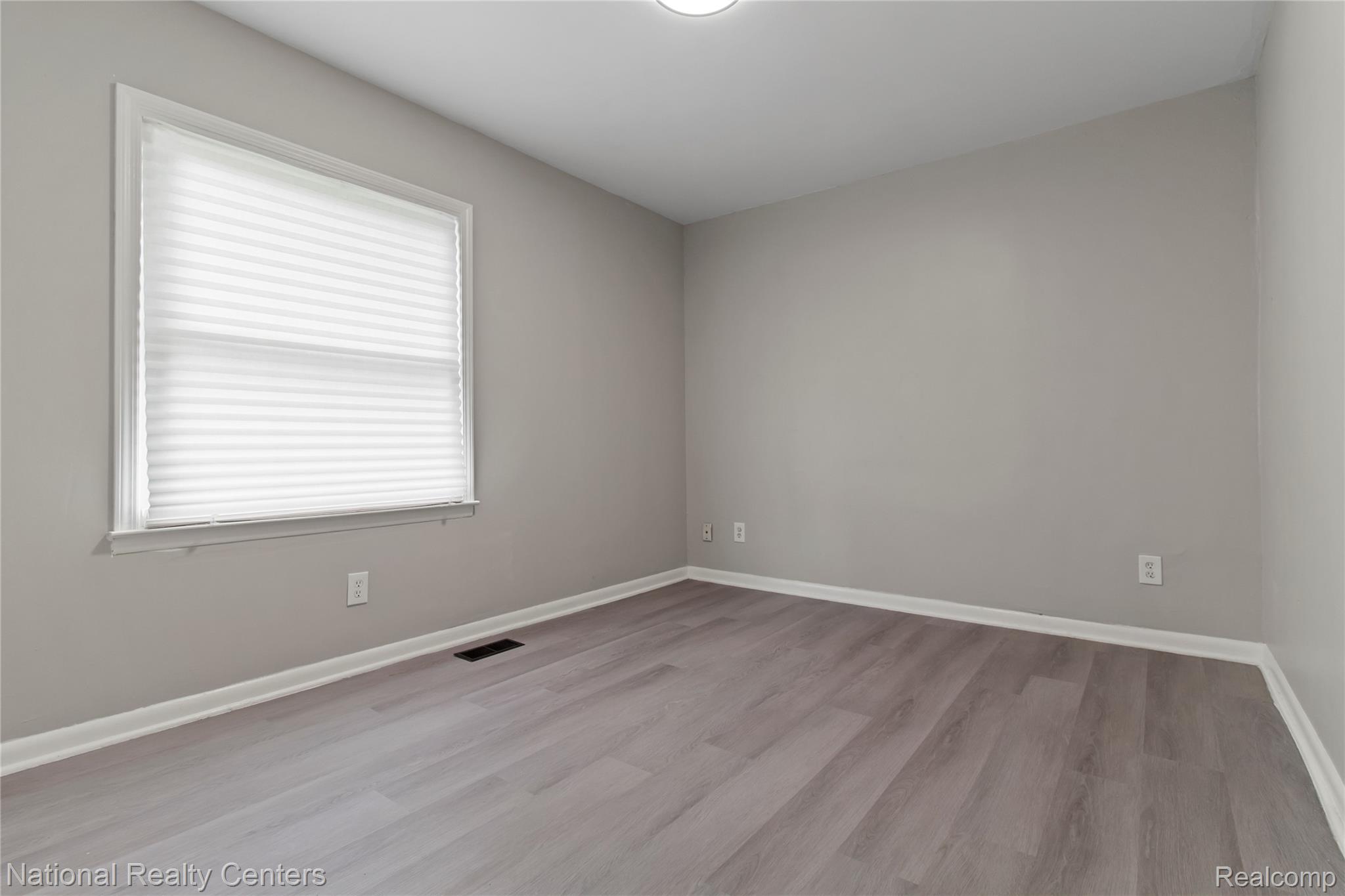 26862 Yale Street Inkster, MI 48141 - Photo 16 of 34 Room featuring wood-finish flooring, neutral wall paint, and white trim