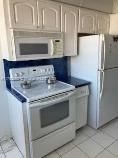 a stove top oven sitting inside of a kitchen