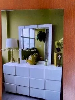 a bedroom with a bed and a mirror