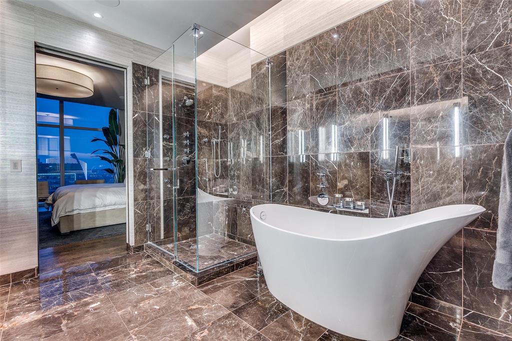 1918 Olive Street, Unit 1603 Dallas, TX 75201 - Photo 15 of 33 a white bath tub sitting in a bathroom and bathroom