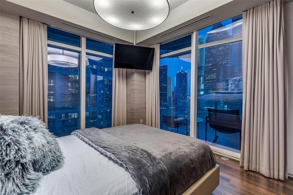 1918 Olive Street, Unit 1603 Dallas, TX 75201 - Photo 18 of 33 a bedroom with a large bed and a walk in closet