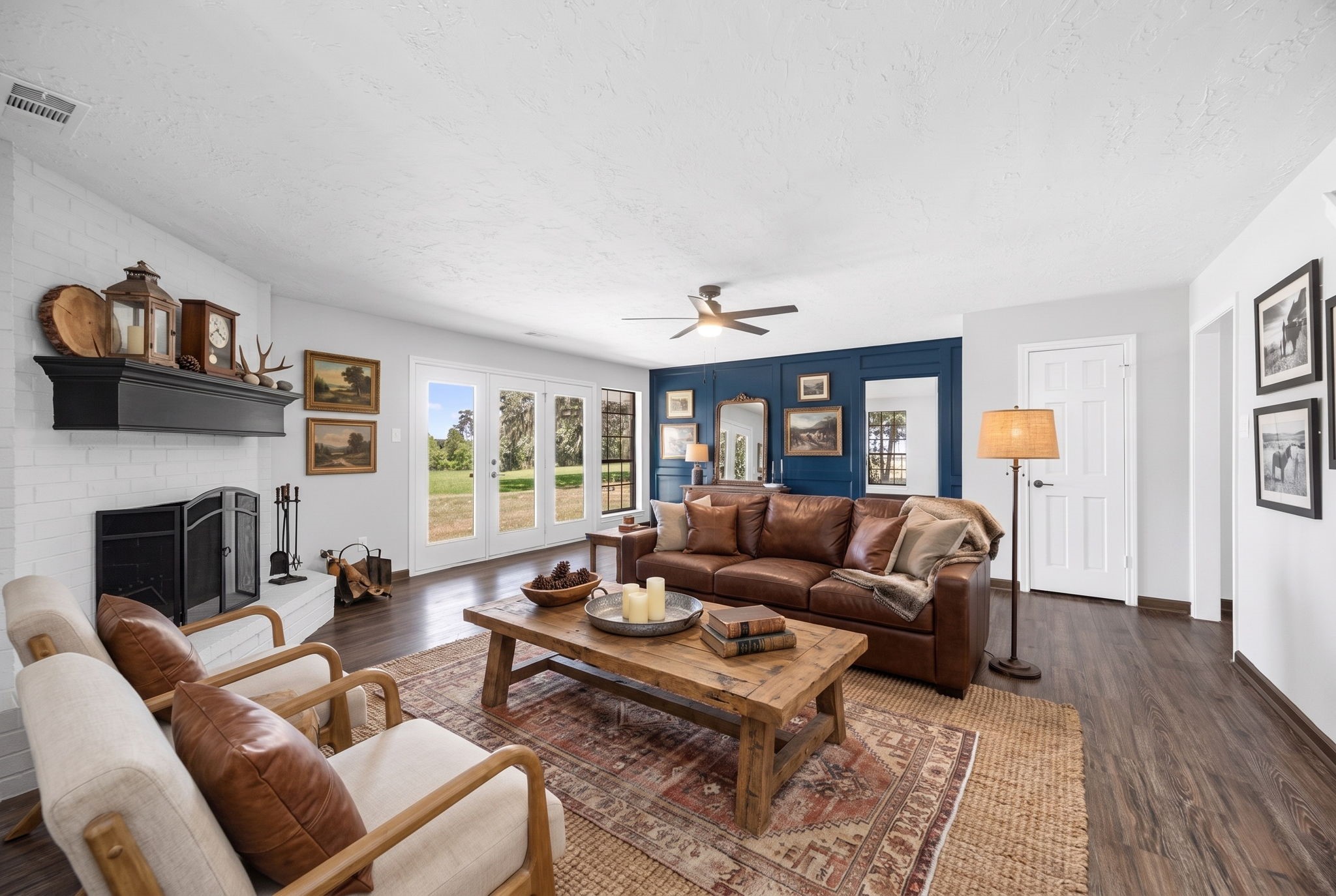 21802 Lake View Road Damon, TX 77430 - Photo 27 of 49 Digitally staged to showcase the warmth and comfort this inviting living room can offer, centered around the cozy fireplace.