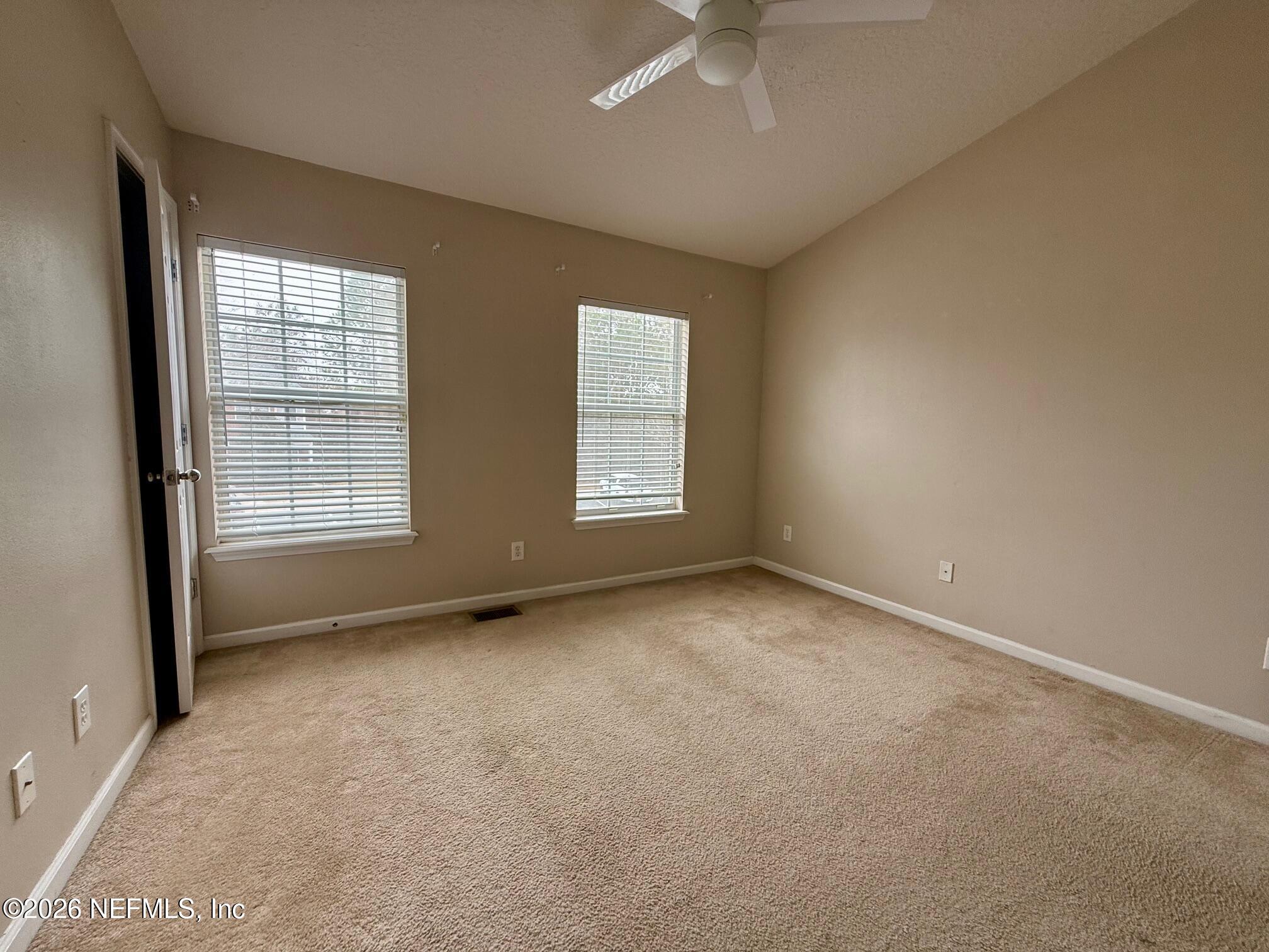 3585 Pebble Path Lane Jacksonville, FL 32224 - Photo 15 of 16 an empty room with windows and fan