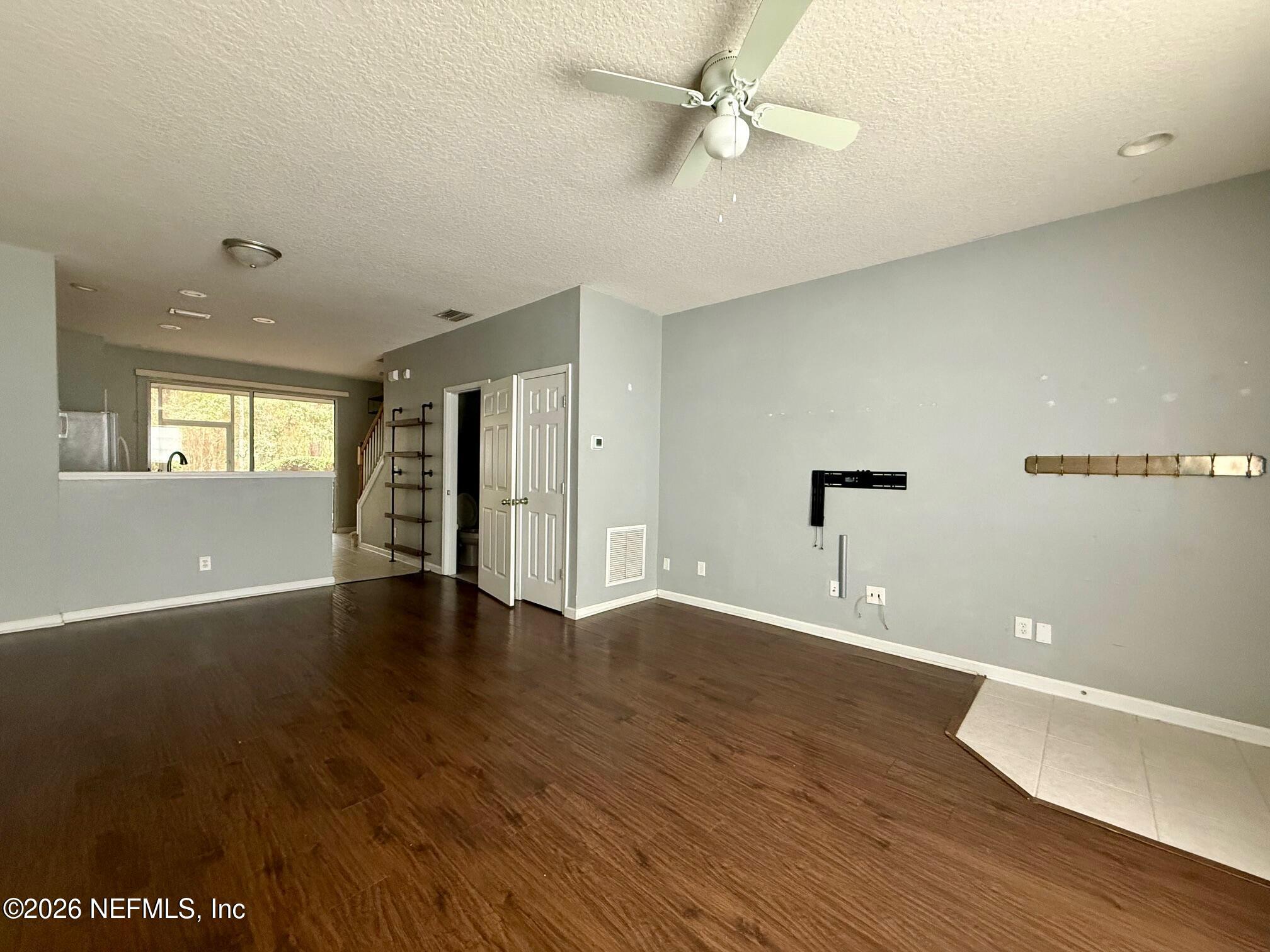 3585 Pebble Path Lane Jacksonville, FL 32224 - Photo 4 of 16 a view of an empty room with wooden floor and a window