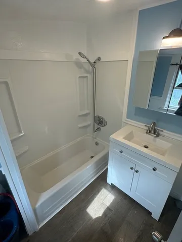 a bathroom with a bathtub and a sink