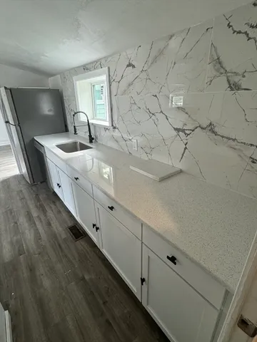 a large white tub sitting in a bathroom