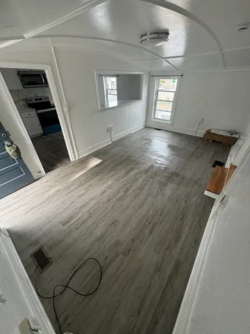 a view of empty room with window and fireplace