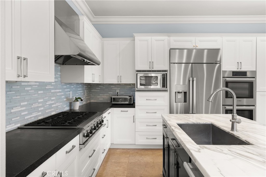 6572 Beachview Drive Huntington Beach, CA 92648 - Photo 5 of 17 a kitchen with granite countertop a sink stove and refrigerator