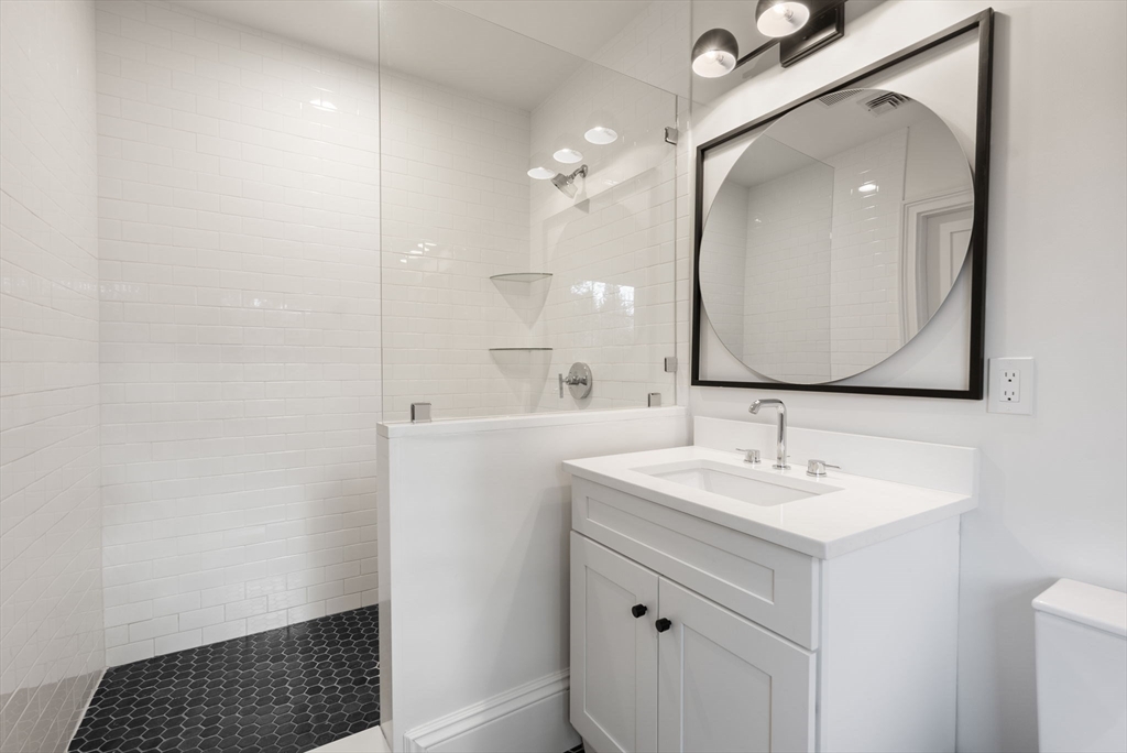 123 Abbott Road Wellesley, MA 02481 - Photo 27 of 42 a bathroom with a sink a vanity a mirror and a toilet