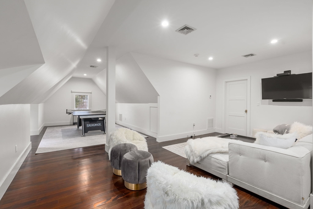 123 Abbott Road Wellesley, MA 02481 - Photo 29 of 42 a living room with furniture and a flat screen tv