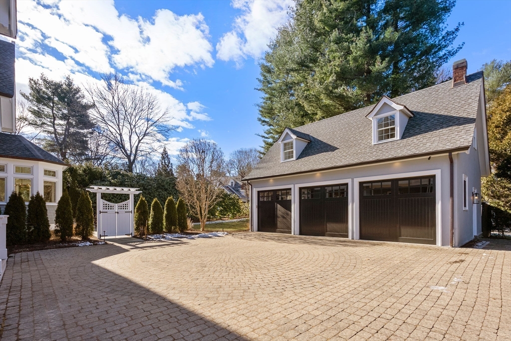 123 Abbott Road Wellesley, MA 02481 - Photo 39 of 42 a front view of a house with a yard and garage