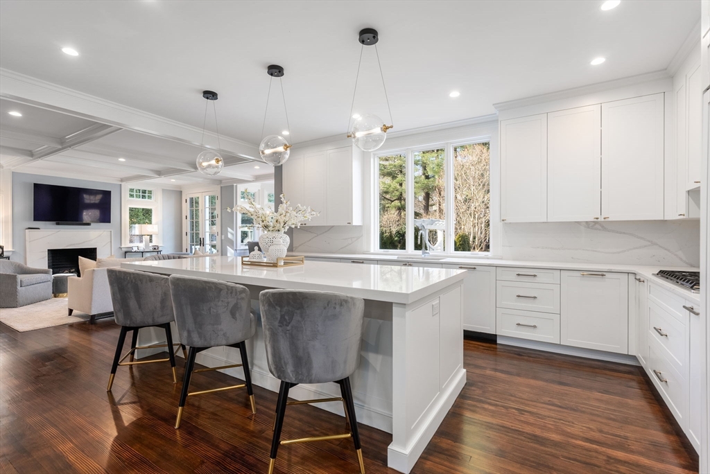 123 Abbott Road Wellesley, MA 02481 - Photo 7 of 42 a kitchen with stainless steel appliances granite countertop a table chairs sink and cabinets