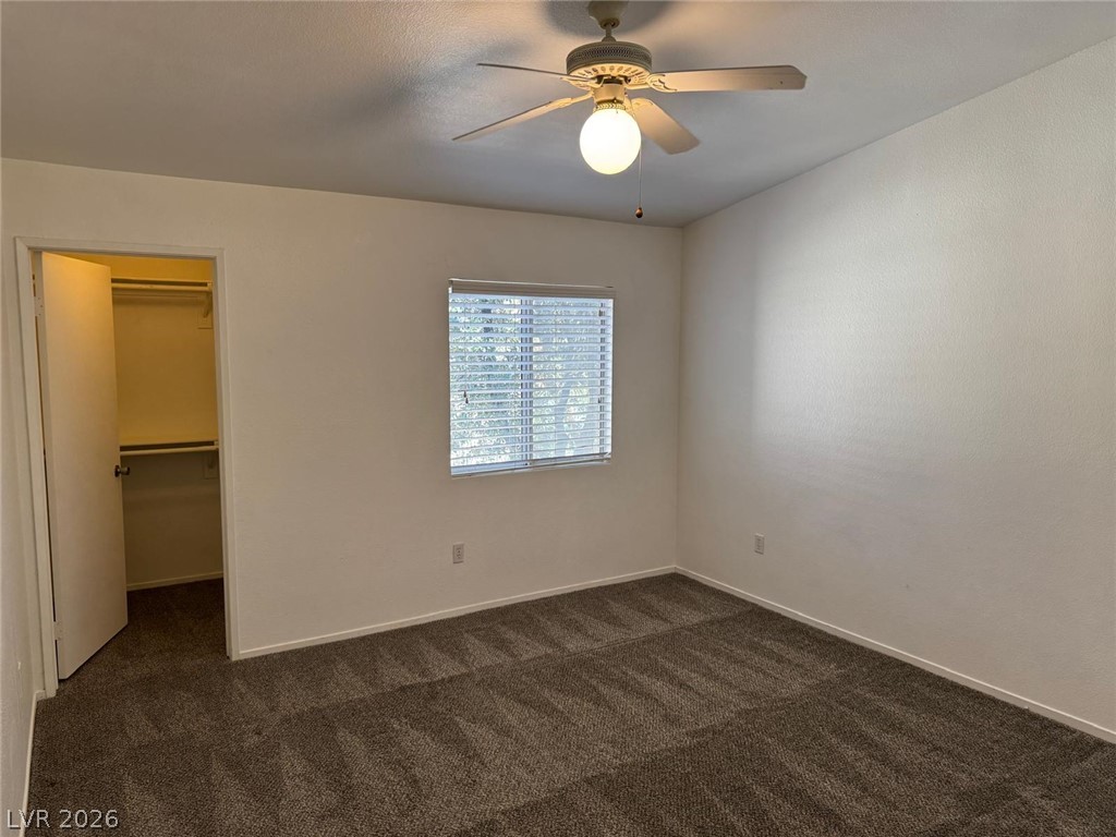 7885 West Flamingo Road, Unit 2171 Las Vegas, NV 89147 - Photo 10 of 22 A well-lit bedroom offering plush carpeted flooring and a convenient walk-in closet.