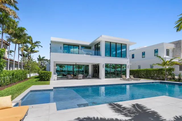 a living room with couches and a large window with garden view