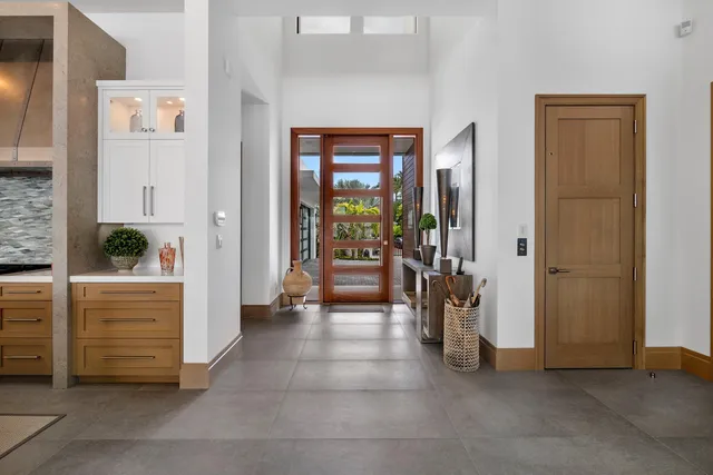 a living room with furniture and floor to ceiling windows
