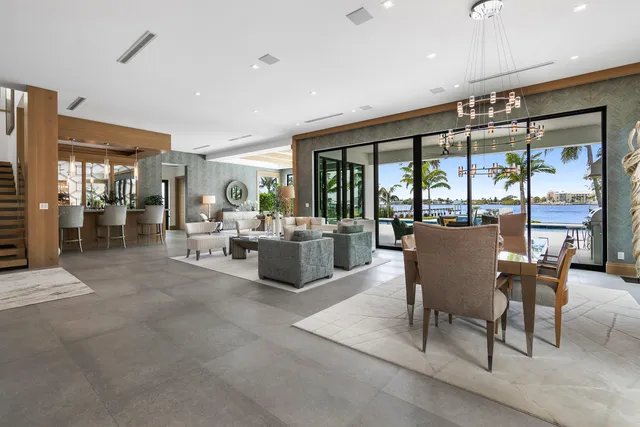 a view of kitchen with stainless steel appliances kitchen island granite countertop a large counter top stainless steel appliances and a large window