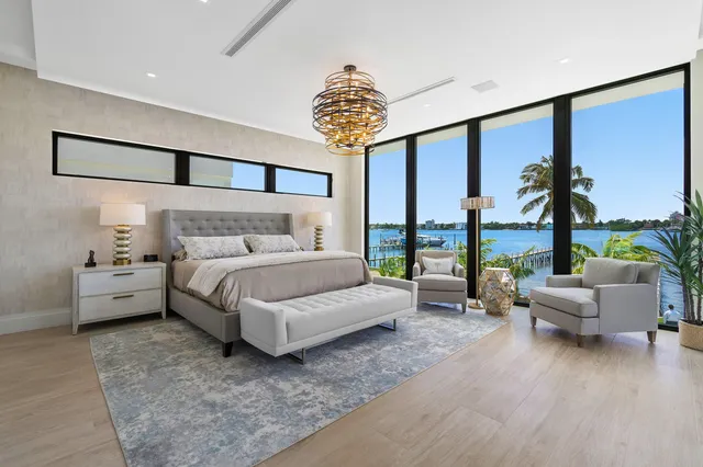 a living room with furniture a rug kitchen view and a window