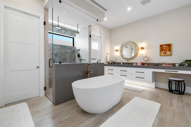 a bathroom with a sink mirror vanity and toilet