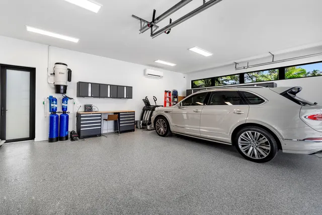 a living room with furniture a chandelier and a floor to ceiling window