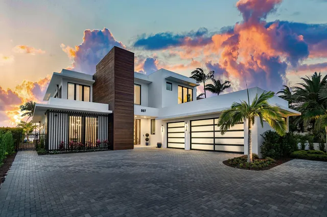 a view of swimming pool with outdoor seating and house in the background