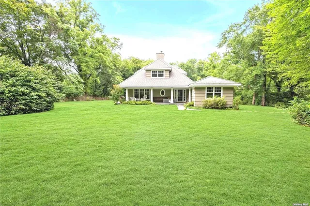 a view of a house with a yard table and chairs