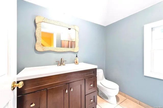 a bathroom with a sink vanity and a toilet